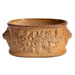 A Brampton brown saltglazed stoneware oval potted-meat dish: applied with floral and lion mask