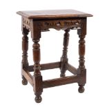 A 17th Century oak joint stool: with a rectangular moulded top, gouged frieze and fret cut apron,