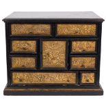 A Continental ebonised and gilded copper table cabinet on a later stand:,