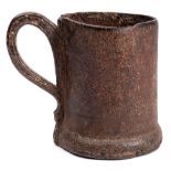 An 18th Century stitched leather tankard: of cylindrical form, with loop handle and a wood base,