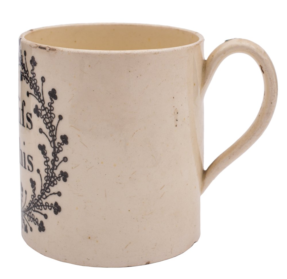 An English creamware small mug: printed in black 'For a Kifs/ Take this' within a foliate cartouche, - Image 2 of 2