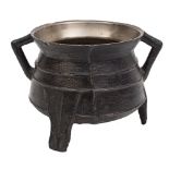 A 16th Century small bronze cauldron: with raised banded decoration and angular loop handles raised