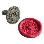 A Medieval bronze seal matrix: the face 'Sigillum Lionel' around a crowned mask,