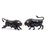 A pair of late 19th Century Viennese cold painted bronze and ivory models of confronting bulls:
