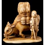 A Japanese carved ivory okimono: of a loaded buffalo and attendant, Meiji period, 3.5cm.