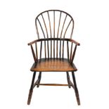 An early 19th Century Cornish ash and birch stick back Windsor elbow chair: the shaped solid birch