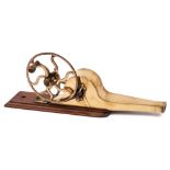 A 19th Century brass and mahogany mechanical bellows: the hand cranked fly wheel with horn handle