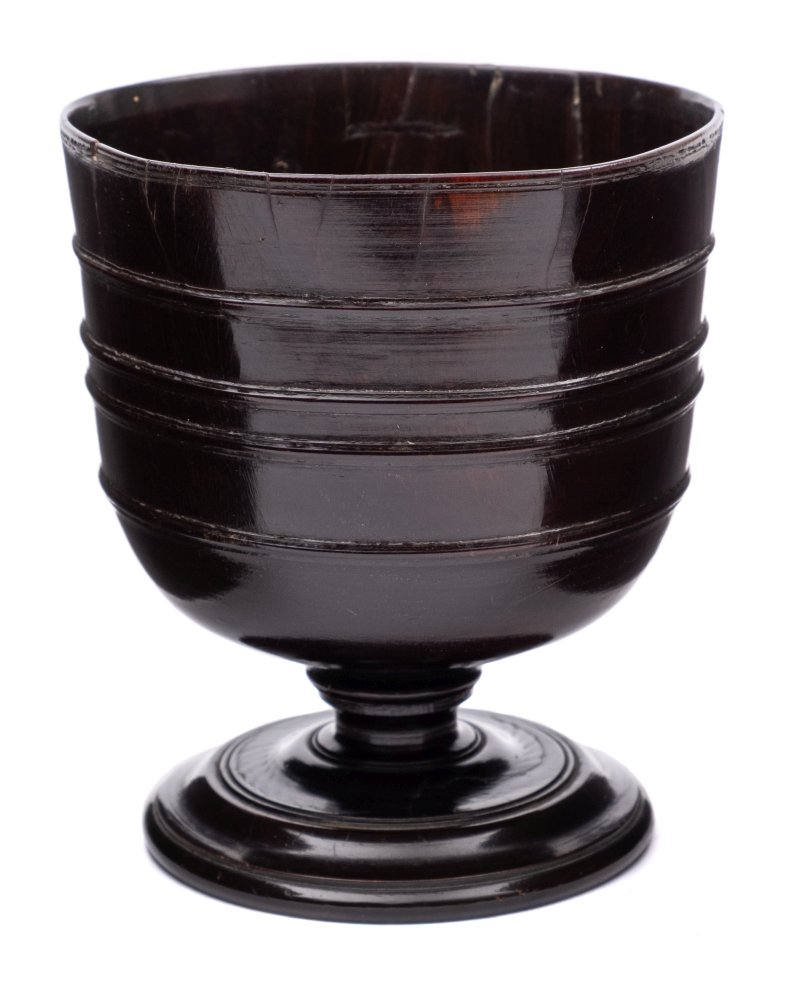 A late 17th Century lignum vitae cup: with four moulded reeds to the body,