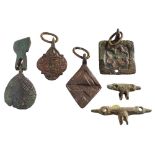 Six late Medieval horse harness pendants: includes T-shaped, lozenge, square and oval examples.