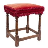 A late 17th/early 18th Century oak stool:, with an upholstered stuff over seat in crimson velvet,