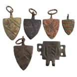 Six late Medieval horse harness pendants: includes five shield-shaped examples and a rectangular