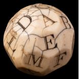 An 18th Century English marine ivory 'teetotum' gambling ball: the twenty-six sides carved and