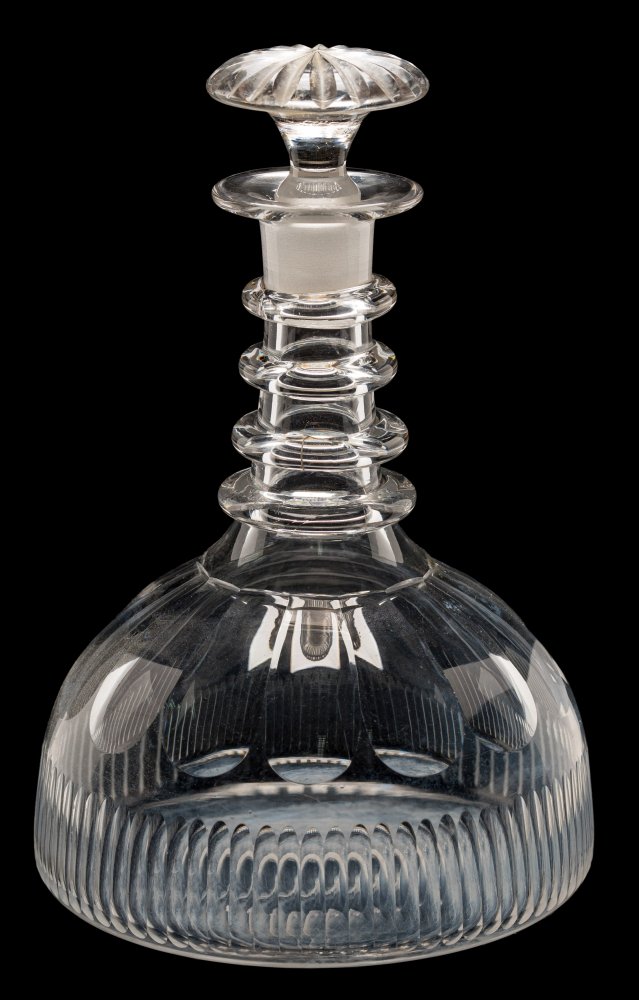 An early 19th century ship's or 'Rodney' glass decanter: of squat domed form with basal flutes