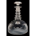 An early 19th century ship's or 'Rodney' glass decanter: of squat domed form with basal flutes