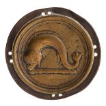 A late 18th Century brass circular cloak badge: depicting a heraldic dolphin,
