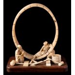 A Japanese carved ivory and bone okimono: in the form of coopers at work,