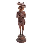 A 19th Century Swiss or Austrian novelty nutcracker: carved as a gentleman wearing a tail coat,