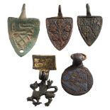 Five late Medieval horse harness pendants: includes three shield-shaped examples,