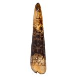 A James I cow horn shoehorn: with incised geometric decoration and dated 1613, 25cm long.