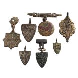 Seven late Medieval horse harness pendants: includes four shield-shaped examples,