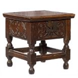 A 17th Century oak square box commode: with a hinged moulded top, the front,