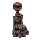 A Regency brass door porter: cast as a lion's paw with turned mahogany ball handle, 19cm high.