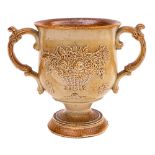 A Brampton salt glazed stoneware loving cup: of goblet-shaped form with scroll handles and foliate