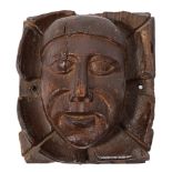 A late 15th/early 16th Century carved oak corner boss or corbel: of a tonsured monk's head, 25.