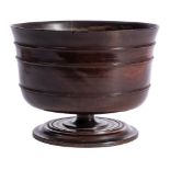 A 17th Century lignum vitae pedestal wassail bowl: of traditional design with reeded ring turned