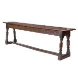 A 17th Century oak West Country bench: the top with moulded edge,