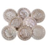 A set of eight large 19th century mother of pearl buttons: engraved with birds in landscapes within