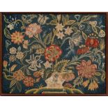 An 18th Century gros-point needlwork panel: worked with a large vase of flowers and foliage,