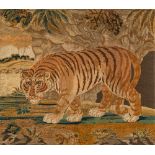 A large Regency silk and woolwork picture of a tiger: walking with head lowered across a landscape,
