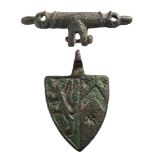 A late Medieval gilt metal horse harness pendant: in the form of a heraldic shield with lion