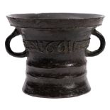 A mid 17th Century mortar: with two loop handles and cast floral band,