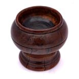 An 18th Century pearwood salt: of circular outline with ring turned decoration, 5cm high.