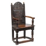 A late 16th Century carved oak caqueteuse armchair:,