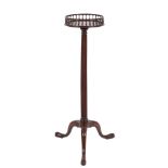 A George III mahogany circular torchere: with a baluster turned brass inlaid galleried top,