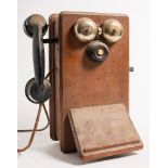 Two Ericsson N2516T mahogany cased wall mounted telephones:, with black bakelite handset,