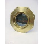 A brass octagonal port hole by Atkey and Son, Cowes: stamped as per title to frame, 28.5cm wide. .