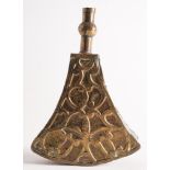 A Moroccan brass powder flask: of triangular form with scroll decorated front,