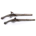 A matched pair of 18th Century Continental silver mounted flintlock pistols:, unsigned,