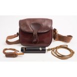 A brown leather cartridge bag together with an Acme 'Dove & Pigeon call' and a wooden duck call:.