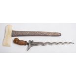 A Malay kris:, the shaped damascus blade over a gem set hilt and shaped wooden grip,