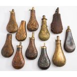 A collection of various copper and brass powder flasks:, all unsigned,
