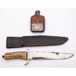 A Bowie style knife:, unsigned with simulated stag horn grip in a black leather scabbard,