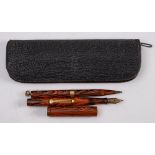A Waterman's Ideal red marbled fountain pen and propelling pencil:,