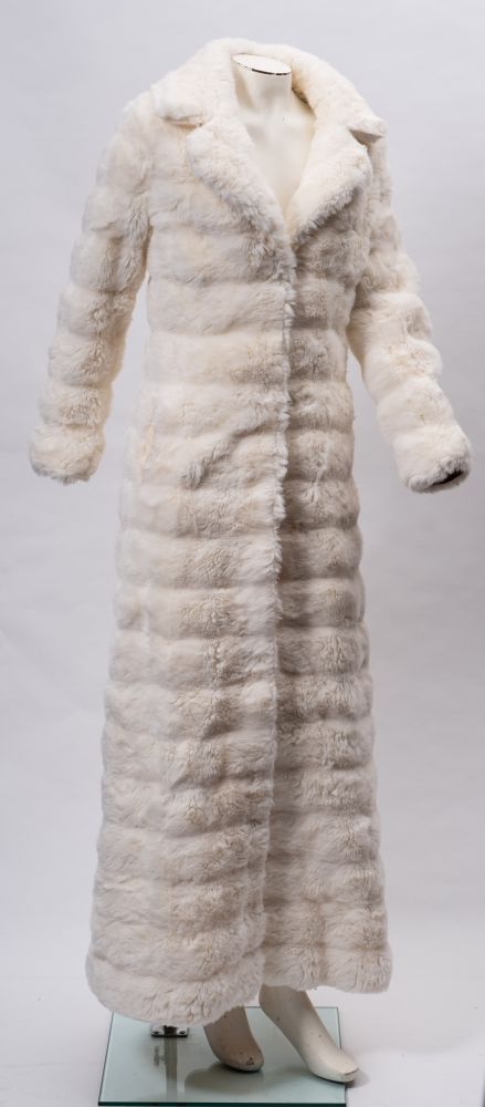 A collection of vintage clothing and textiles: including white faux fur full length coat and a