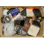 A collection of various 35mm filters and ring adapters:,