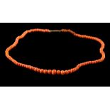 A coral bead single-string necklace: with coral beads graduated from 4mm to 7mm diameter with gilt